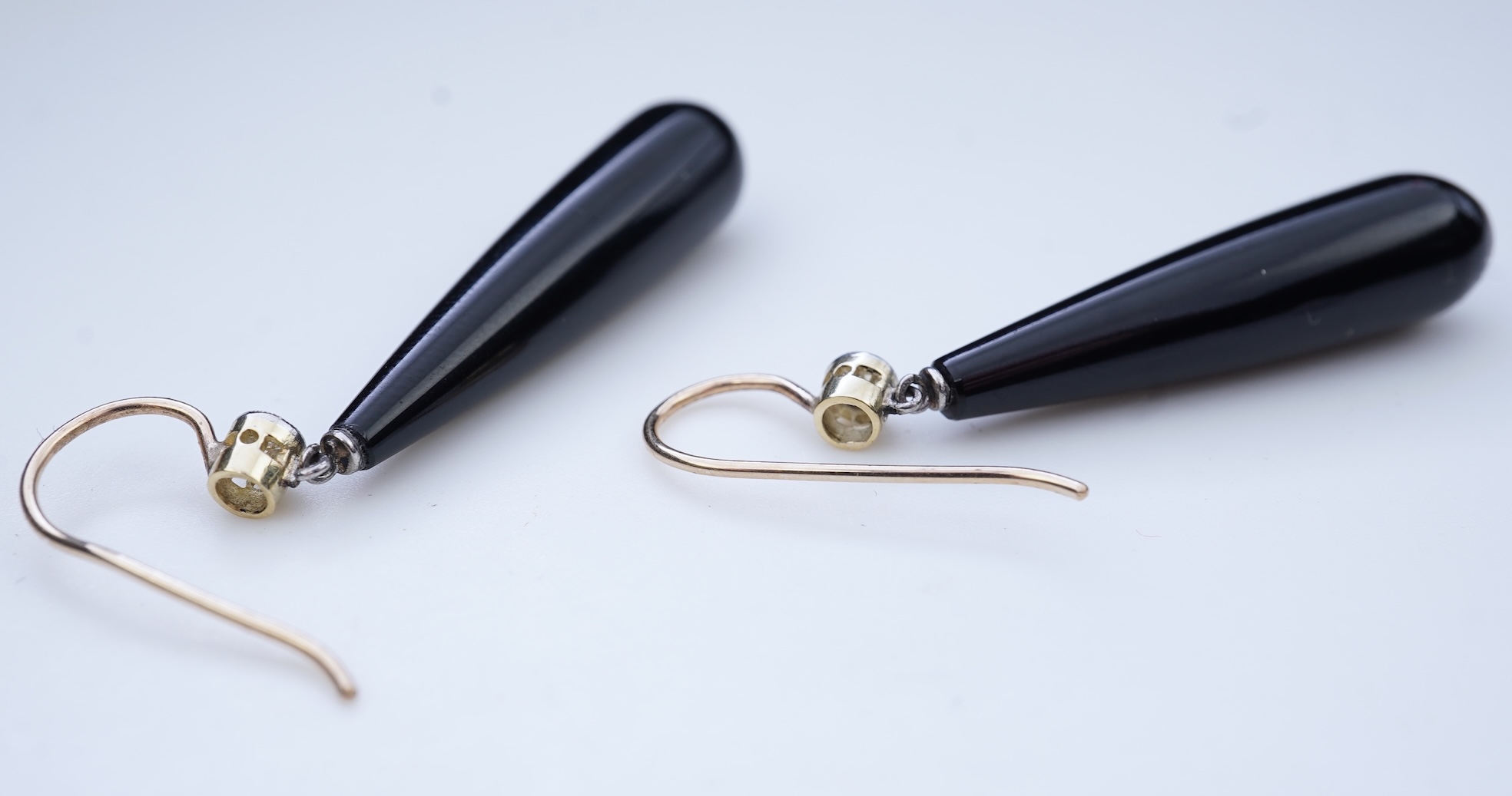 A pair of Art Deco onyx and diamond earrings, early 20th century